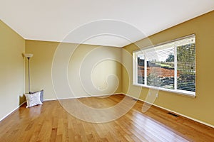 Empty room in soft ivory with new hardwood floor