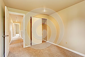 Empty room in soft ivory tones with closet