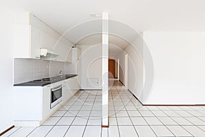 Empty room with vintage kitchen, white tiles and walls