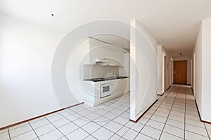 Empty room with vintage kitchen, white tiles and walls