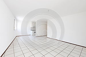 Empty room with vintage kitchen, white tiles and walls