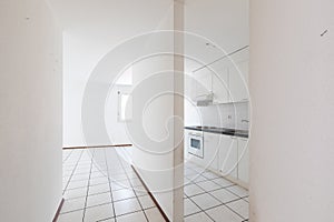 Empty room with vintage kitchen, white tiles and walls