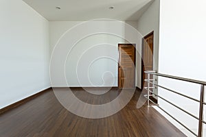 Empty room, white mortar wall background and wood laminate floor