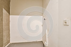 an empty room with a white wall and a door