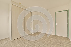 an empty room with white walls and sliding doors