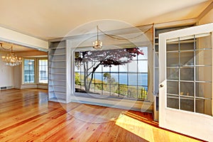 Empty rooms with water view and large windows.