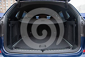 Empty roomy open trunk of modern crossover car, copy space, Rear view of a car with an open trunk, close up, soft focus