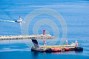 Empty RoRo or Roll-on roll-off barge and white tug boat