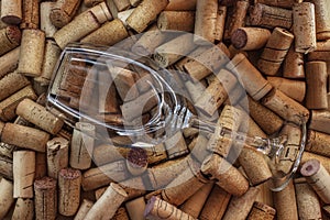 Empty round glass of wine surrounded by wine corks. Restaurant menu background