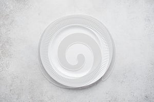 Empty round plate on light gray concrete background