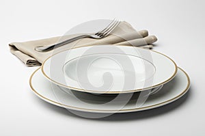 Empty round white plate and bowl with napkin and fork