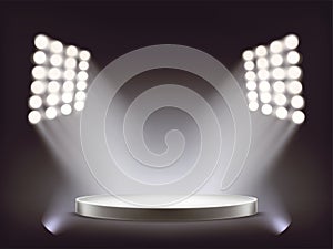 Empty round white podium illuminated by spotlights