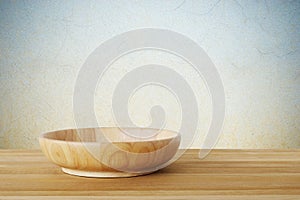 Empty round wooden plate on wood table background, food display