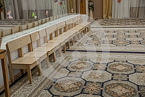 Empty row of wood children chairs in music room before celebration in music-hall waiting party