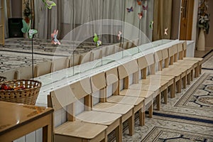 Empty row of wood children chairs in music room before celebration in music-hall waiting party