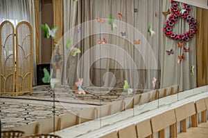 Empty row of wood children chairs in music room before celebration in music-hall waiting party