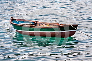 Empty rowing boat floating in the water.