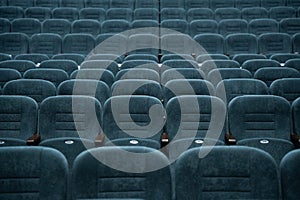 Empty rows of seats in the hall for a large number of people. Cinema and theatre hall for watching performances.