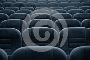 Empty rows of seats in the hall for a large number of people. Cinema and theatre hall for watching performances.