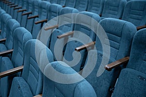 Empty rows of seats in the hall for a large number of people. Cinema and theatre hall for watching performances.