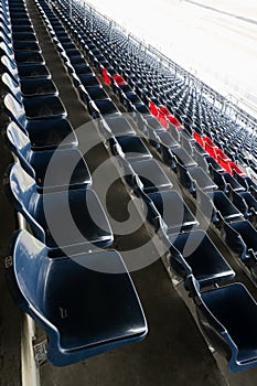 Empty Rows of stadium grandstand seats or stadium seats, plastic blue and red seats on grand stadium pattern.