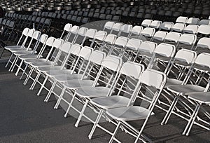 Empty rows of white chairs