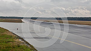 Empty runway at the passenger airport in the rain