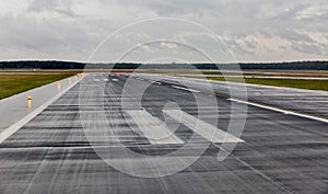 Empty runway at the passenger airport in the rain