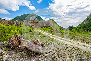 Empty rural road through rugged terrain