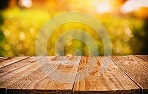 Empty rustic table in front of abstract background