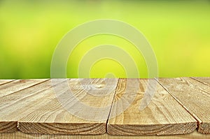 Empty rustic table in front of abstract background