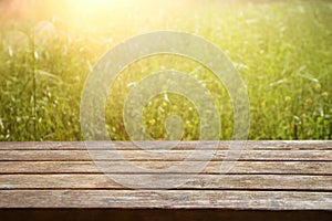 Empty rustic table in front of countryside background. product display and picnic concept