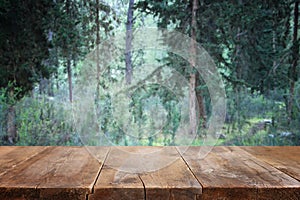 Empty rustic table in front of countryside background. product display and picnic concept