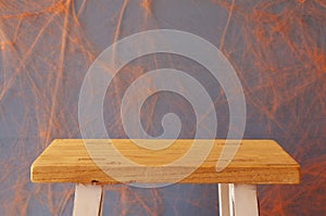 Empty rustic table in front of spider web background