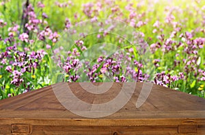 Empty rustic table in front of spring beautiful flowers background