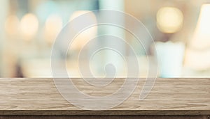 Empty rustic wood table and blurred soft light table in restaurant with bokeh background. product display