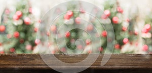 Empty rustic wood table top with abstract blur christmas tree re