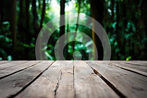 Empty rustic wood texture of old wooden tabletop, blur on green forest background Displaying layout, mounting your product,