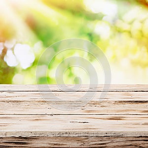 Empty rustic wooden table with golden sunlight