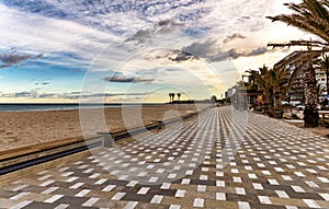 Empty San Juan beach promenade in Alicante, Spain, at sunset.