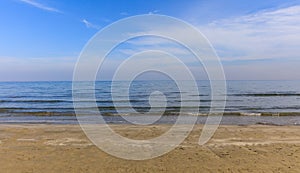 Empty sandy beach. Blue sky and sea at evening. Closeup view.