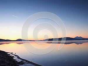 Empty sandy beach in island in romantic colors of tropical sunset. The foot steps in sand.