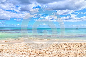 Empty Sandy Beach and Sea with Cloudy Sky Background