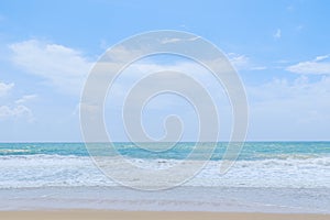 Empty sandy beach with sea under blue sky