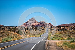 Empty scenic highway in Arizona, USA. Natural american landscape with asphalt road to horizon. Desert highway at sunset