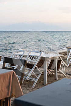 empty seaside restaurant tables