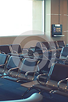 Empty seats in the boarding area of an airport