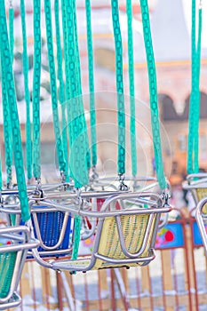 Empty seats of childrens carousel in amusement park