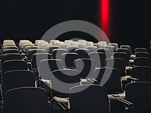 Empty seats in a dark room at a business conference