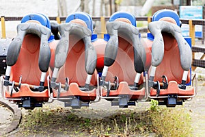 Empty seats of an extreme carousel in an amusement park. Broken carousel. Selective focus.